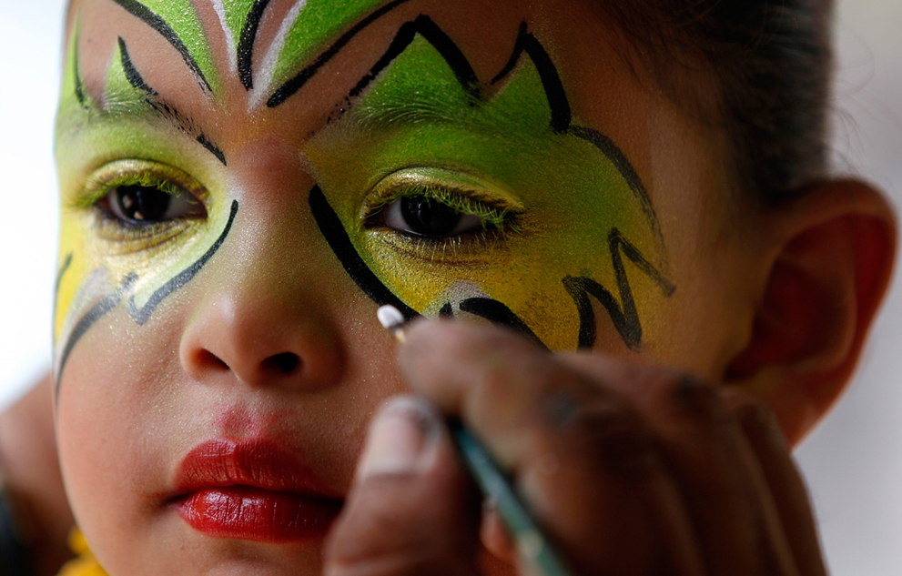 Девочке накладывают макияж для  карнавала в Galapa