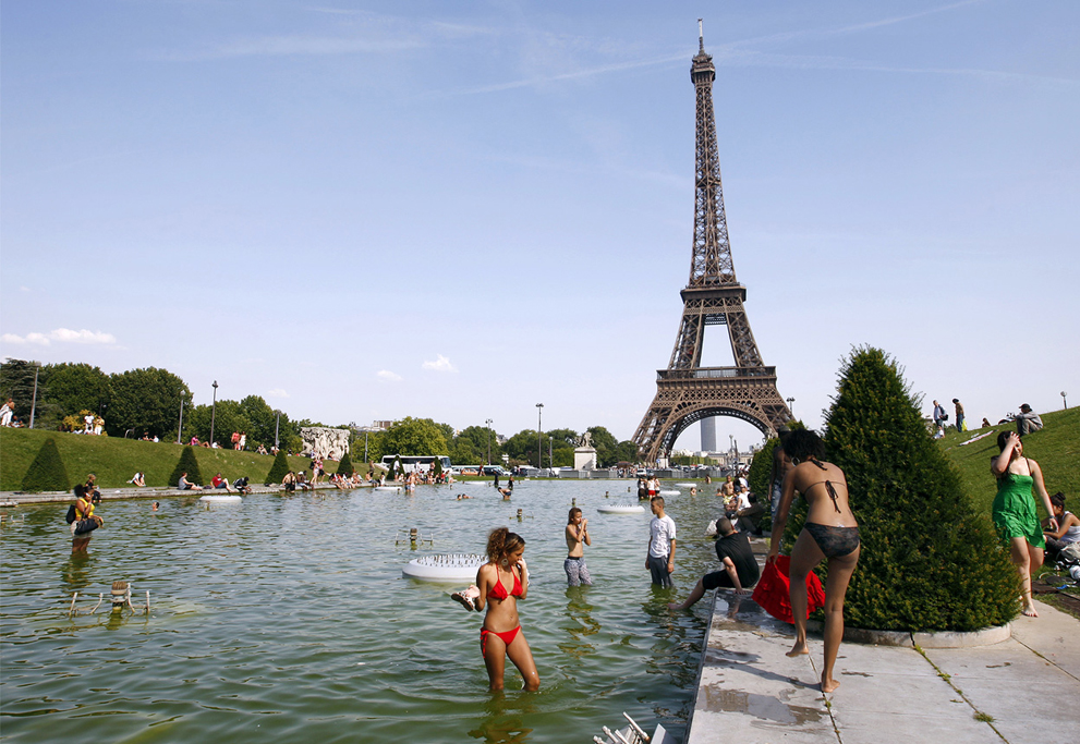 Люди охлаждаются в фонтанах перед Эйфелевой башней, 27 июня 2011 года в Париже, страшная жара.